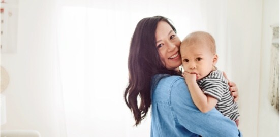A mother holding her baby.
