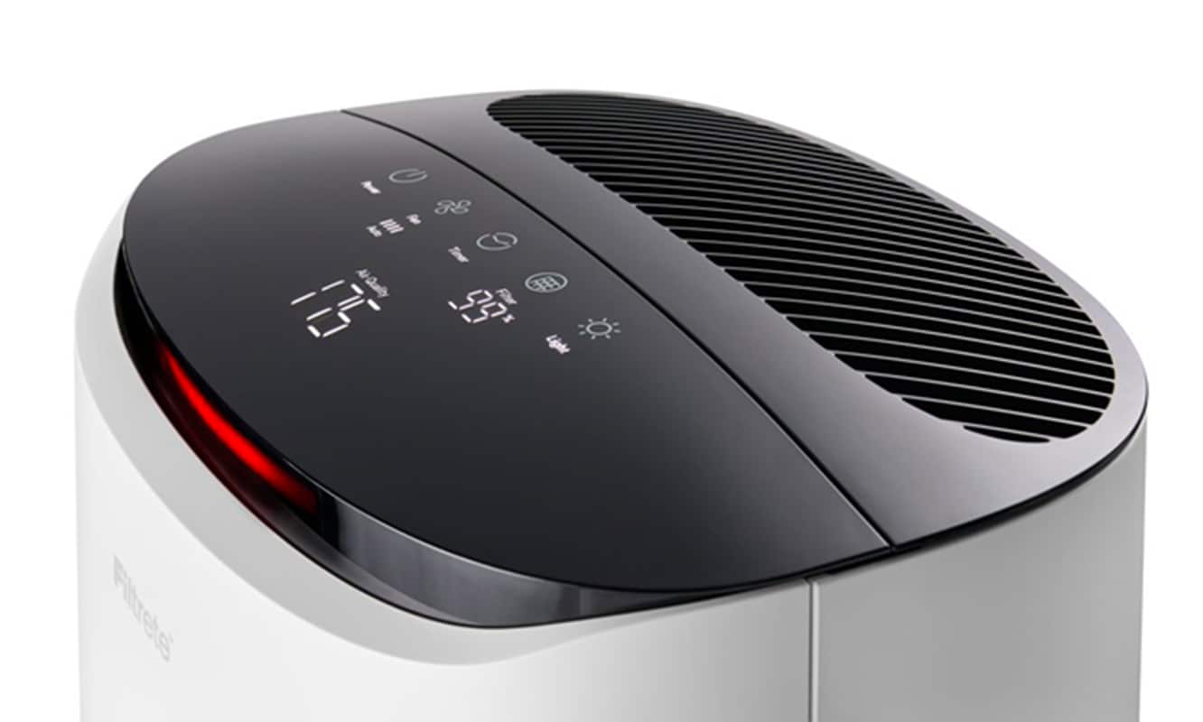 Close-up view of the top of a Filtrete™ Smart Air Purifier displaying digital readouts of monitoring.
